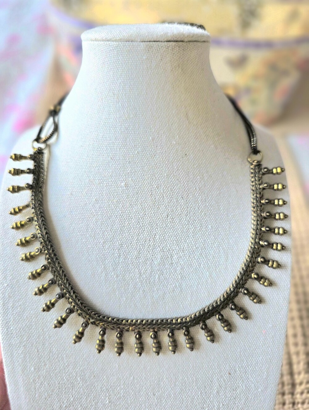 Antique-finish brass tribal collar necklace featuring a woven snake chain design